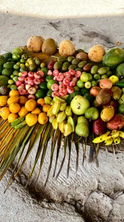 A vibrant assortment of fresh tropical fruits arranged on a palm leaf in Seychelles.