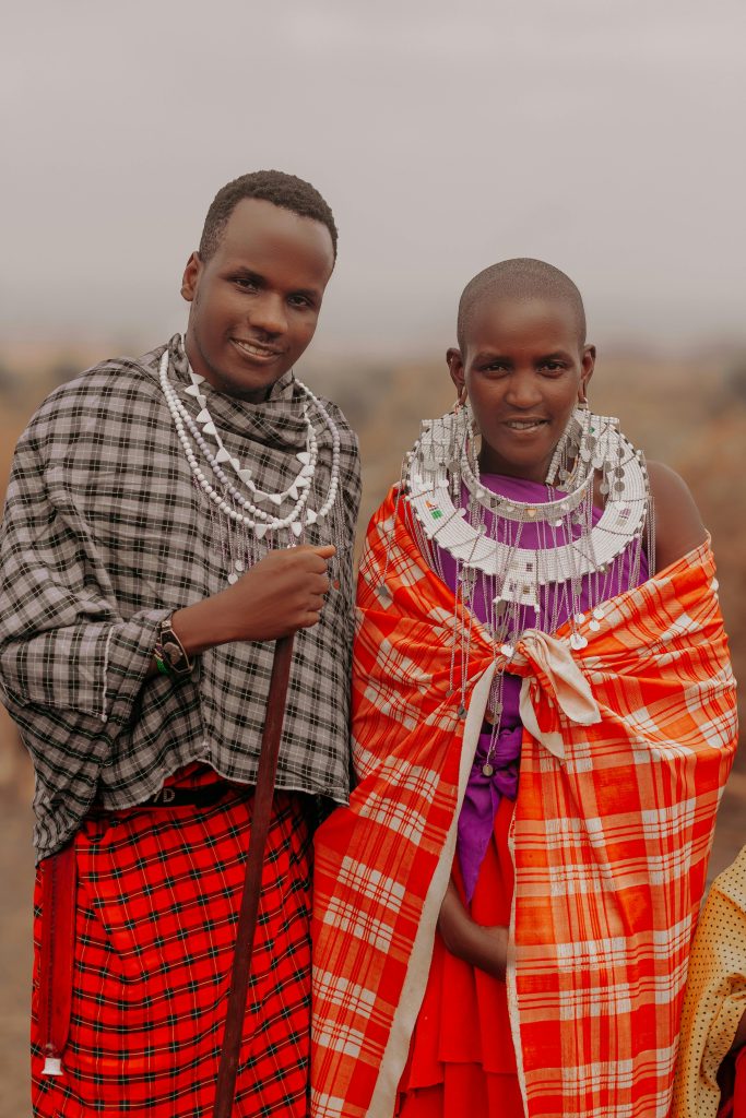 Two Maasai individuals in colorful traditional attire, showcasing cultural heritage.
