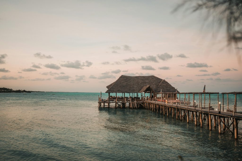 Scenic pier extending into the Indian Ocean at sunset, capturing the serene beauty of Zanzibar.